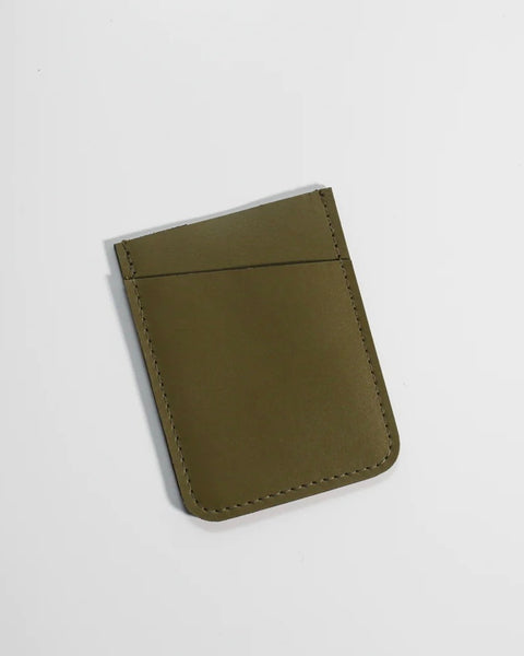the Small Hours Slim Leather Card Holder in Olive laying flat tilted on an angle against a white background