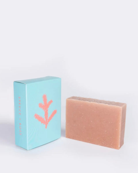 the ALTR Spruce & Rose Bar Soap and it's box sitting side by side on an angle against a neutral background