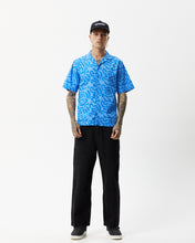 Load image into Gallery viewer, the Afends Men&#39;s Icebergs Short Sleeve Shirt in Arctic on a model standing straight on staring into the camera
