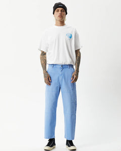 the Afends Men's Richmond Workwear Jean in Faded Arctic on a model standing straight on staring into the camera
