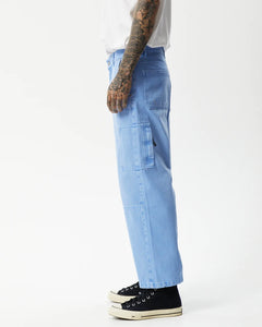 the side view of the Afends Men's Richmond Workwear Jean in Faded Arctic on a model