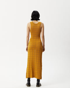 back view of the Afends Women's Femme Dress in Mustard on a model standing with her hands by her sides