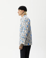 Load image into Gallery viewer, side view of the the Afends Men&#39;s Waterfall daisy printed Long Sleeve Shirt in White on a model standing with his hands by his sides

