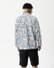 Load image into Gallery viewer, back view of the the Afends Men&#39;s Waterfall daisy printed Long Sleeve Shirt in White on a model posing with his hands by his sides and head turned toward his right shoulder
