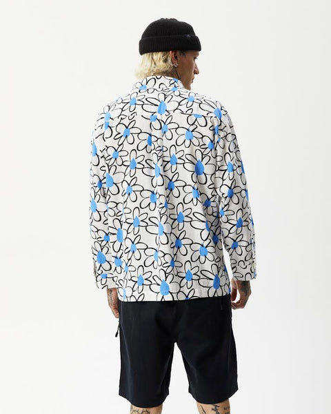 back view of the the Afends Men's Waterfall daisy printed Long Sleeve Shirt in White on a model posing with his hands by his sides and head turned toward his right shoulder