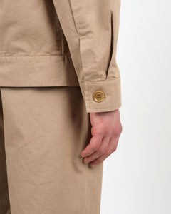a close up of the sleeve button placket of the Wemoto Men's Ethan Jacket in Khaki on a model