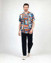 Load image into Gallery viewer, the Wemoto Men&#39;s Vernon Short Sleeve Shirt in Red on a model standing in front of a neutral background
