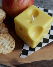 Load image into Gallery viewer, closeup of the Drop Dead Swiss Cheese Cube Candle on a charcuterie board
