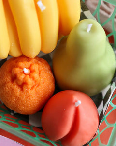 close up of the the Drop Dead Fruit Basket Candles in a green basket