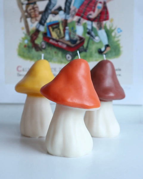 the Drop Dead Retro Mushroom Candle in yellow, orange and brown