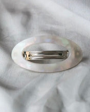 Load image into Gallery viewer, the Horace Maria oval Hair Clip in cream shot from above laying on grey fabric
