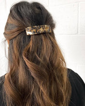 Load image into Gallery viewer, a large rectangular hair barrette worn in a half up style by a model with long brunette hair shot at the back of her head
