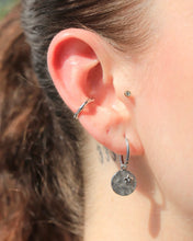 Load image into Gallery viewer, the the Horace Hammered Ear Cuff worn on an ear with a silver dangly earring
