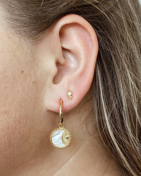 the Horace Gemma Stud Earring shown in an ear in the second piercing along with a dangly earring in the first hole