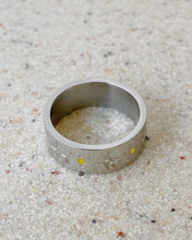 Load image into Gallery viewer, the Horace Sparka Ring in silver laying flat on a speckled stone surface
