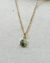 Load image into Gallery viewer, the Horace Zoto Necklace in gold shot with a close up of the green agate gemstone laying flat against a neutral background
