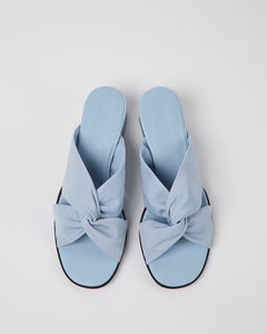 overheard shot of a pair of blue sandals with a knotted front
