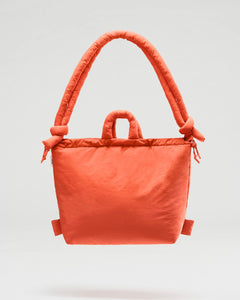 the Ölend Ona Soft Bag in coral floating against a neutral background