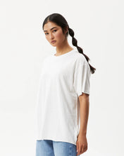 Load image into Gallery viewer, Afends Women&#39;s Slay Oversized Tee in White on a model posing in front of a white background
