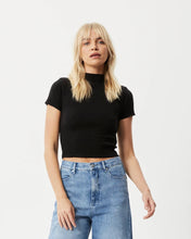 Load image into Gallery viewer, the Afends Women&#39;s Iconic Rib Tee in Black on a model posing in front of a white background
