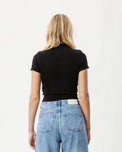 Load image into Gallery viewer, back view of the the Afends Women&#39;s Iconic Rib Tee in Black on a model posing in front of a white background
