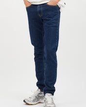 Load image into Gallery viewer, close up view of the front of the Dr. Denim Men&#39;s Clark Jean in Rubble on a model posing in front of neutral background with his hands in his pockets
