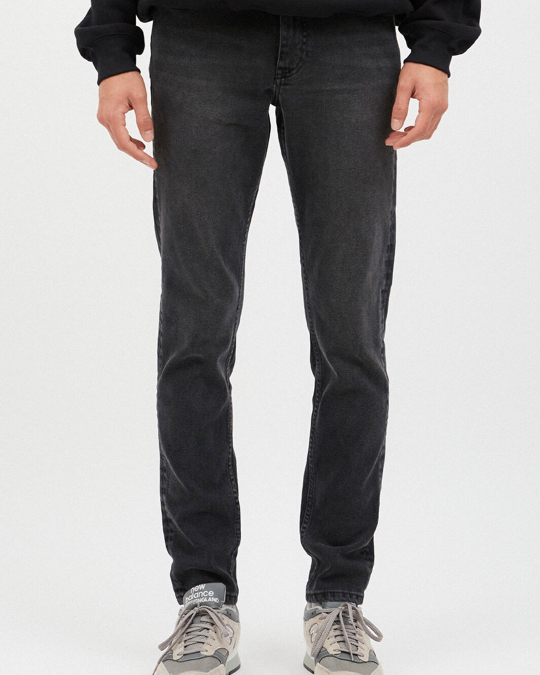 close up of the front view of the Dr. Denim Men's Clark Jean in Cinder on a model standing in front of a neutral background