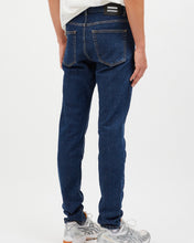 Load image into Gallery viewer, close up view of the back of the Dr. Denim Men&#39;s Clark Jean in Rubble on a model posing in front of neutral background
