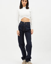 Load image into Gallery viewer, the Dr. Denim Women&#39;s Beth Jean in Stream Rinse on a model posing in front of a neutral background staring straight into the camera
