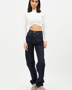 the Dr. Denim Women's Beth Jean in Stream Rinse on a model posing in front of a neutral background staring straight into the camera
