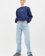 Load image into Gallery viewer, the Dr. Denim Women&#39;s Beth Jean in Stream Light Used on a model posing with her hands in her front pockets
