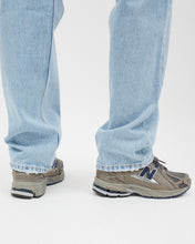 Load image into Gallery viewer, close up of the hem of the Dr. Denim Women&#39;s Beth Jean in Stream Light Used on a model paired with trendy grey new balance sneakers

