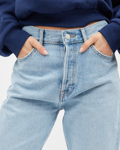 close up of the front fly of the Dr. Denim Women's Beth Jean in Stream Light Used on a model posing with her hands in her pockets