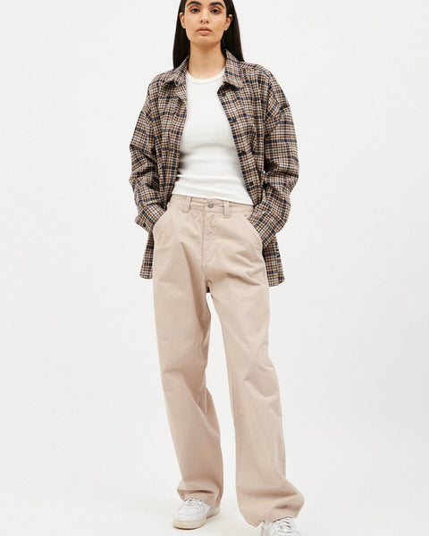 the Dr. Denim Women's Donna Jean in Pale Taupe on a model posing with her hands in her front pockets
