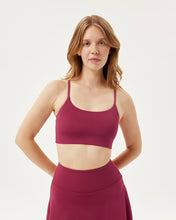 Load image into Gallery viewer, model posing with her hands behind her back wearing the Girlfriend Collective Ultralight Juliet Bra in Rhododendron
