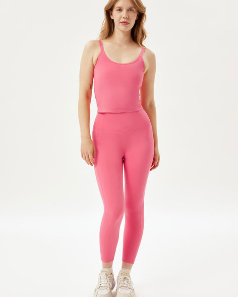 the Girlfriend Collective High-Rise Crop Legging in Camellia worn by a model