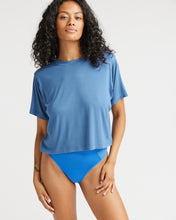 Load image into Gallery viewer, model posing in the Richer Poorer Women&#39;s Night Knit Tee in Blue Horizon and blue briefs looking into the camera
