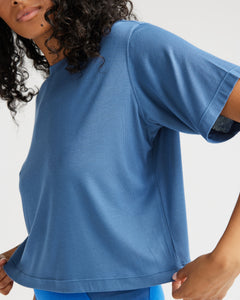 close up side view of model wearing the Richer Poorer Women's Night Knit Tee in Blue Horizon 