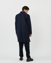 Load image into Gallery viewer, Back view of the Minimum Men&#39;s Balano Coat in Navy Blazer on a model worn with black pants and dress shoes
