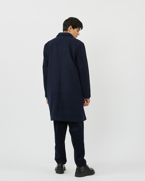 Back view of the Minimum Men's Balano Coat in Navy Blazer on a model worn with black pants and dress shoes
