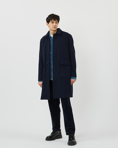 Front view of the Minimum Men's Balano Coat in Navy Blazer on a model layered over a denim shirt
