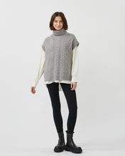 Load image into Gallery viewer, front view of a model wearing the Minimum Women&#39;s Cablina Sweater Vest in Gull with black leggings and black combat boots
