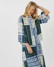 Load image into Gallery viewer, Model posing in the Minimum Women&#39;s Nilana Blouse in Impression paired with the matching plaid skirt
