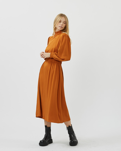 front view of the Minimum Women's Larada Midi Dress in Roasted Pecan worn by a model styled with black boots