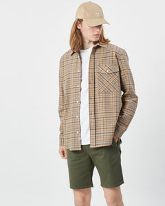 the Minimum Men's Woad Overshirt in Brown Sugar on a model posing with his head to the side