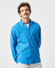 Load image into Gallery viewer, the Minimum Men&#39;s Jay Shirt in French Blue on a model posing with his hands behind his back
