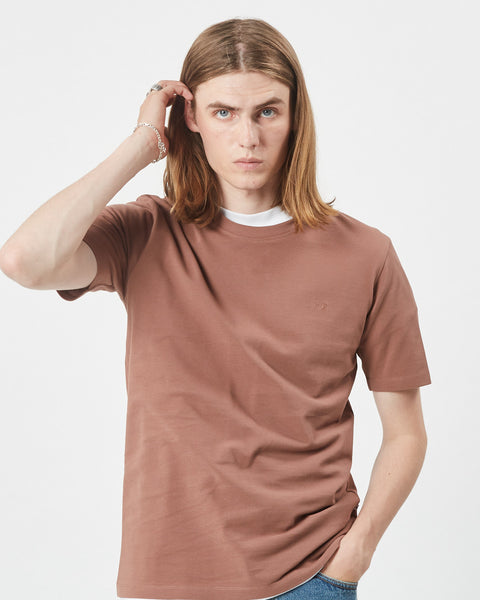 the Minimum Men's Sims T-Shirt in Clove on a model posing with his hand in his hair