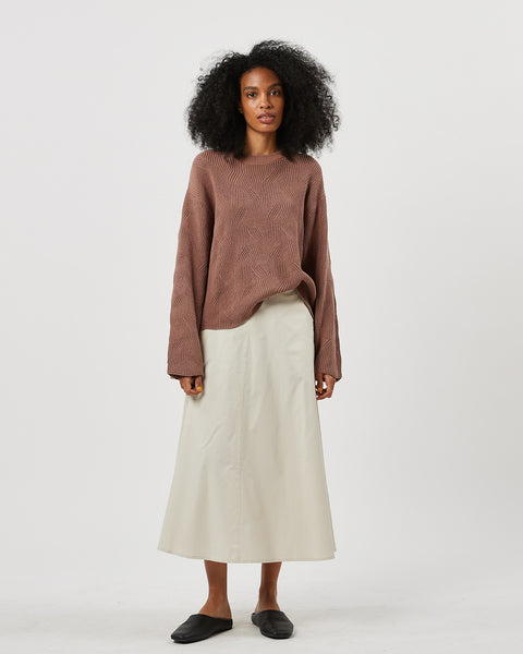 the Minimum Women's Innia Sweater in Brownie on a model standing looking into the camera