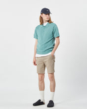 Load image into Gallery viewer, the Minimum Men&#39;s Cavli Polo in Oil Blue on a model posing with his hand in his pocket
