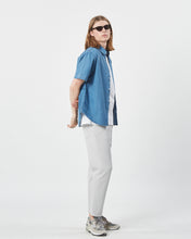 Load image into Gallery viewer, the Minimum Men&#39;s Eric Shirt in Faded Denim on a model standing to the side with his arms crossed behind his back
